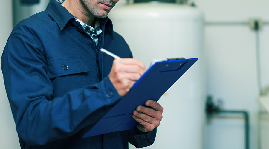 home inspector writing on clipboard
