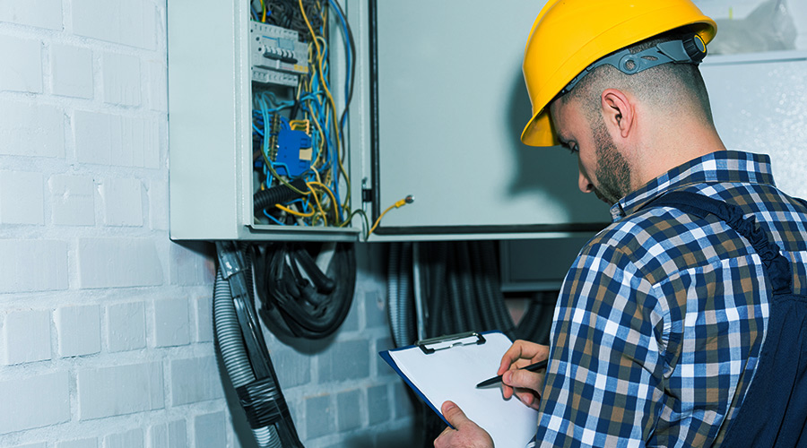 inspector checking houses electrical system